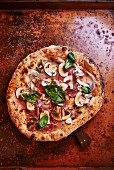 Ham, mushroom and basil pizza (seen from above)