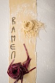 An arrangement of fresh noodles and the word Ramen