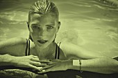 A blonde woman at the edge of a pool