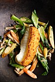 Monk fish with a ginger crust on a bed of stir-fried vegetables with coconut milk