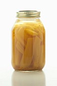 Homemade pickled bananas in a screw-top jar