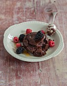 Vegan chocolate cake with maple syrup and fresh fruits of the forest