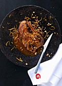 Roasted duck with orange sauce and walnuts
