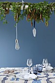 Arrangement of fir branches suspended above set table