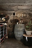 Christmas in a wine cellar: a wine rack and a barrel of wine with a candelabra