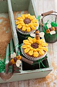 Courgette and almond cupcakes decorated with sunflowers and marzipan bees