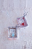 Silver love notes for hanging up made with fine glitter and pipe cleaners
