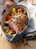Roast turkey roulade with vegetables in a braising pot