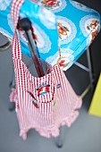 A checked cloth on a colourfully patterned barstool