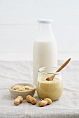 A jar of peanut mousse and peanut milk in a glass bottle