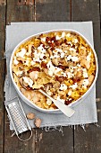 Farfalle bake with chicken, mushrooms, dried tomatoes, cream and feta cheese