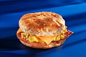 An American biscuit with ham, scrambled egg and cheese