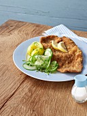 Wiener Schnitzel (breaded veal escalope from Vienna) with potatoes and cucumber salad