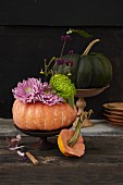 Autumnal pumpkin decoration with asters and chrysanthemums
