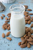 A bottle of almond milk and almonds