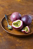 Passion fruits on a wooden dish