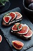 Slices of bread topped with cream cheese and figs