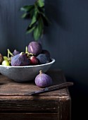 A bowl of fresh figs and grapes