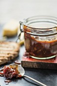 Tomato chutney in a jar and on a spoon