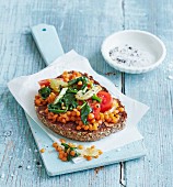 Lentil bruschetta with baby spinach and plum tomatoes
