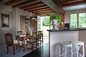 Counter, barstools and dining set with carved chairs in old country house