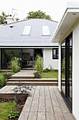 Wooden deck and walkways leading to modern house