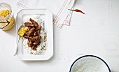 Stir-fried pork fillet in chilli caramel on a bed of rice (Asia)