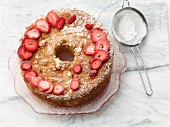 Jewish sponge cake with strawberries and icing sugar