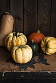 Various pumpkins on an old wooden chest