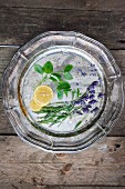 ingredients for gin and tonic with lavender flowers on a silver tray