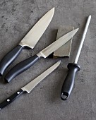 Various knives, a whetstone and a sharpening steel