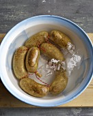 Sausages in a bowl of iced water