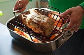 Roast pork and vegetables in a roasting tin