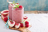 White peach and raspberry smoothies in jars