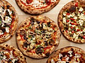 Pizzas with different toppings (seen from above)