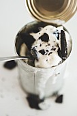 An ice cream dessert with Oreo cookies served in a tin can