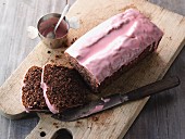 Red wine cake with nuts and pink frosting