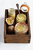 Preserving jars with passion fruit spread in a wooden crate