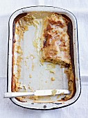 The remains of creamy strudel in a baking dish
