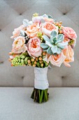 A bridal bouquet with pink flowers and succulents
