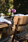 Rustic wooden table and chair on restaurant terrace