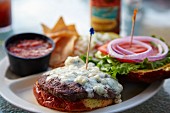A blue cheese burger with salsa