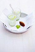 Glasses of avocado and elderflower lassi with coriander and spiced falafel