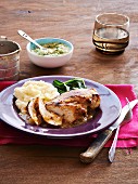 Chicken breast with a mustard glaze, mashed potatoes and leafy greens
