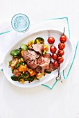 Grilled steak with cherry tomato skewers and potato salad