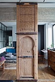 Moroccan handcrafted wooden element as sliding element in front of a bedroom area
