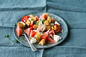 Bread salad with watermelon, cherry tomatoes and feta cheese
