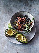 Vegetarian courgette rice with blueberries and grilled avocado