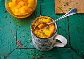 Sweet and sour mug cake with pumpkin, processed cheese and chives