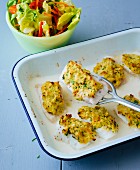 Gratinated fish fillets with a herb crust and a side salad